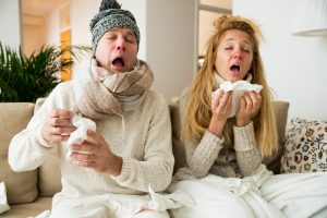 Sick couple catch cold. Man and woman sneezing,